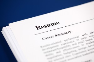 Stack of resumes on a blue background.